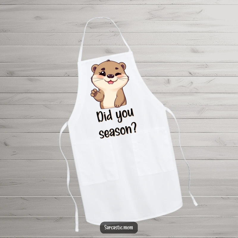 Funny otter apron, smiling with one eyebrow raised and paw gesturing, ready for kitchen adventures. A fun funny gift.