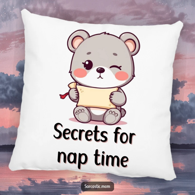 Funny cute bear cub with a knowing wink holding a tiny rolled-up scroll on a soft, decorative pillow.