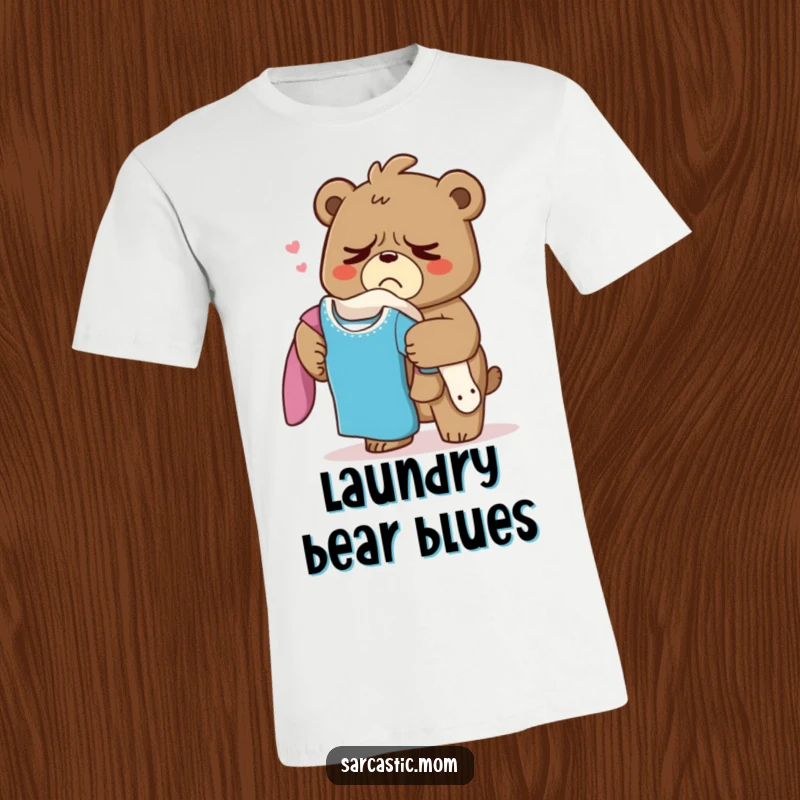 Funny Grumpy Bear Mom T-Shirt, a tired mama bear sighing with a huge laundry pile, symbolizing the relatable exhaustion of chores.