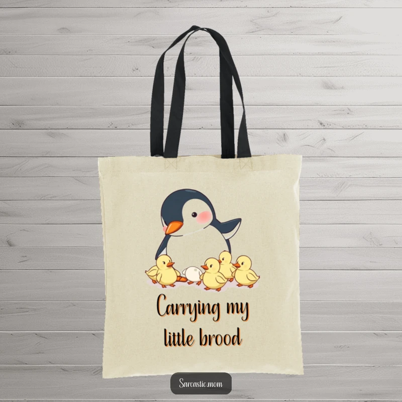 Funny tote bag showing a penguin mom herding ducklings, a practical and humorous accessory for moms on the go.